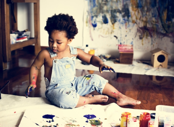 Black kid enjoying his painting