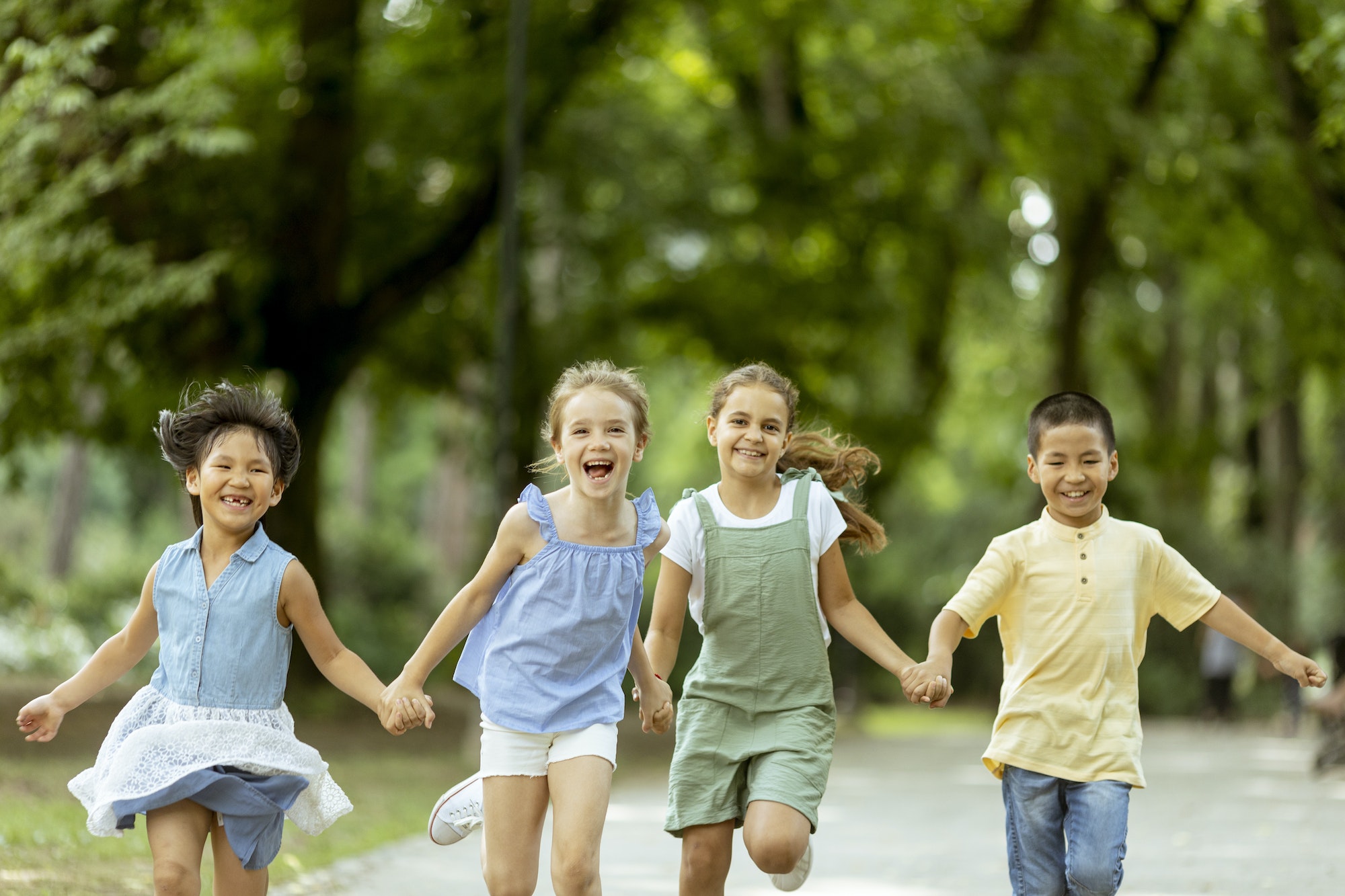 Group of asian and caucasian kids having fun in the park