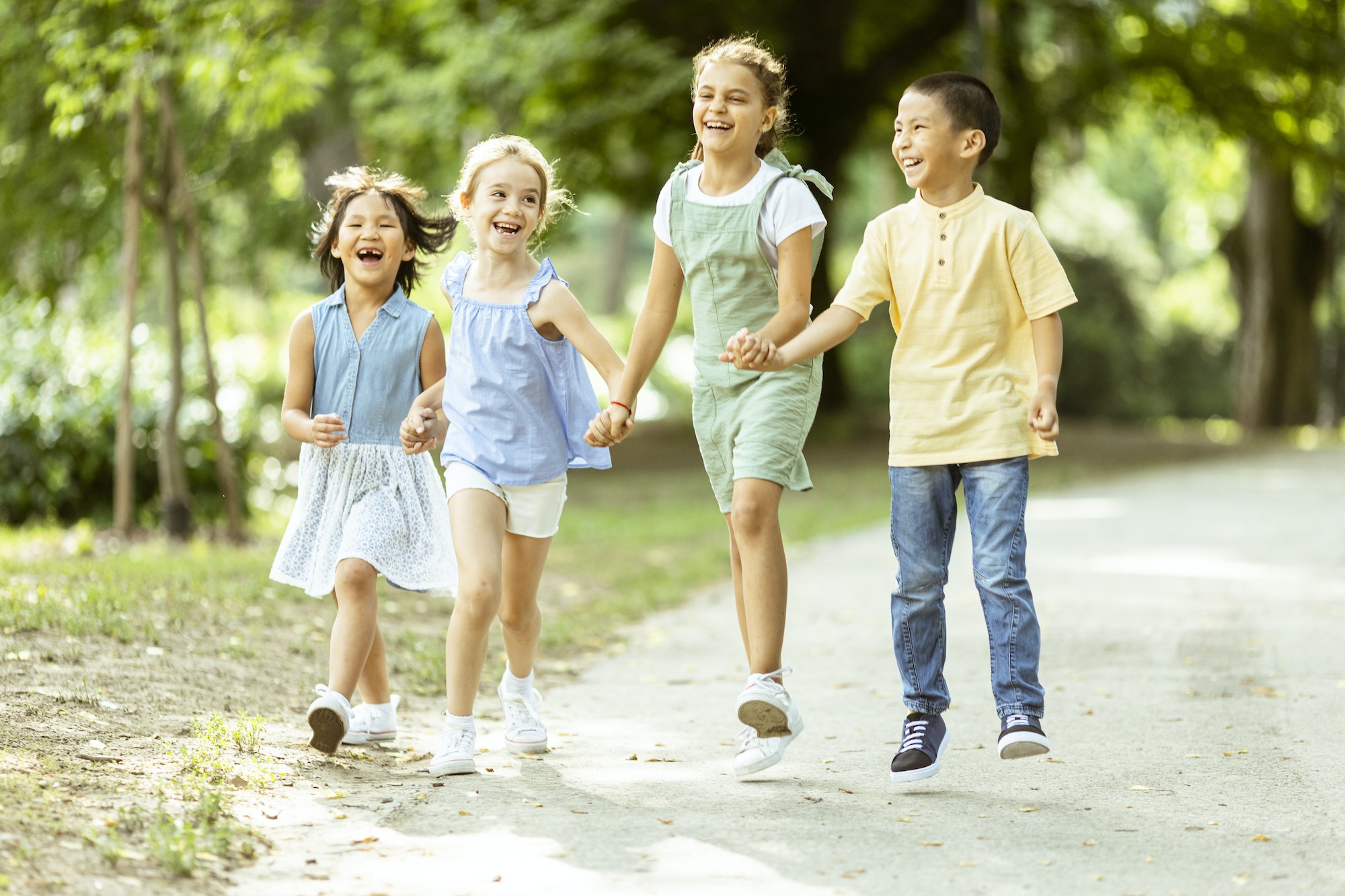 Group of asian and caucasian kids having fun in the park