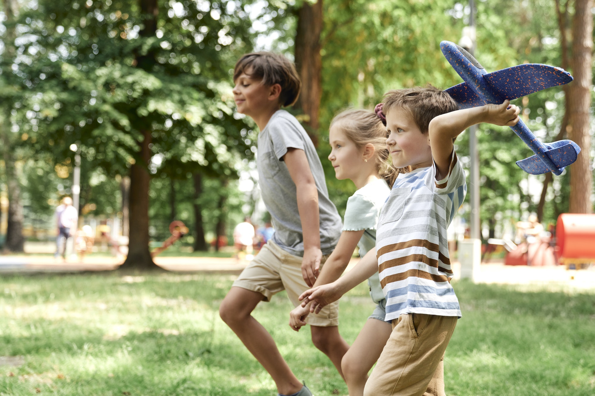 Group of kids playing together with airplane toy